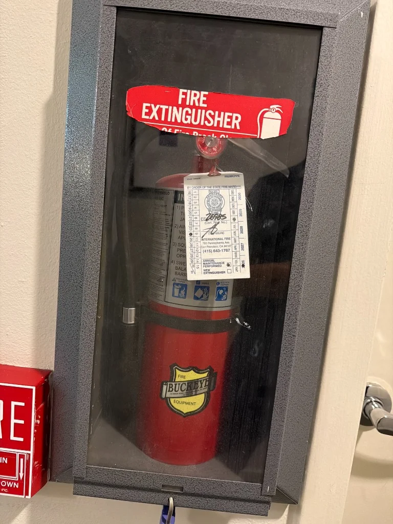 Buckeye fire extinguisher housed in a break-glass wall cabinet